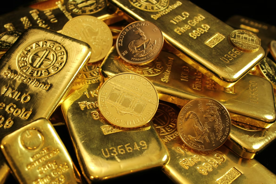 Gold bars and coins representing how gold performs during economic crises.