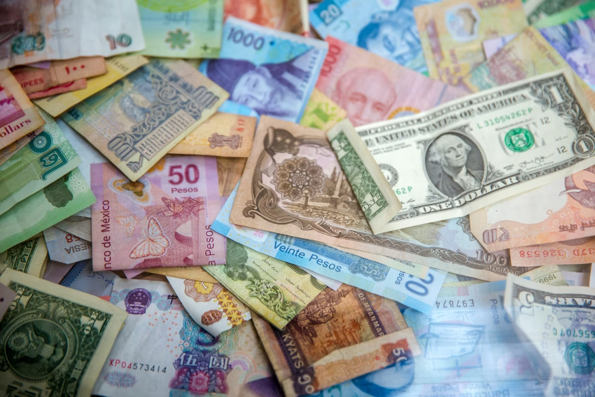 Different currencies displaying how devaluation takes place and how investors can protect against it.